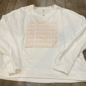 Fabletics crewneck fleece with LA logo in white and pink. Size XL